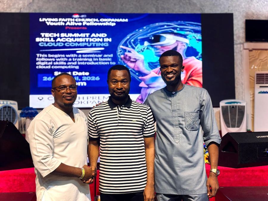 Guest speakers and pastors posing together in front of the Tech Summit and Skill Acquisition in Cloud Computing banner at Living Faith Church, Okpanam