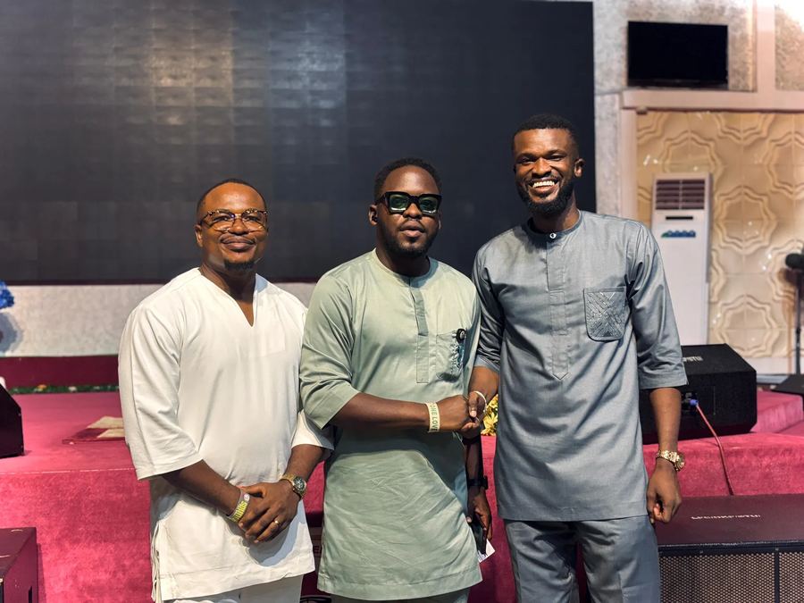 Three speakers posing together on stage after the Tech Summit and Skill Acquisition in Cloud Computing seminar